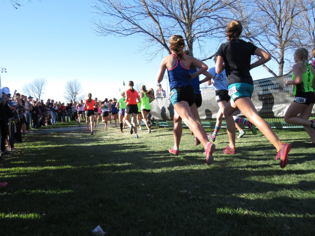 Runners pass spectators during a race.